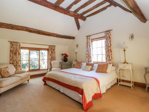A bed or beds in a room at Mickle Trafford Manor
