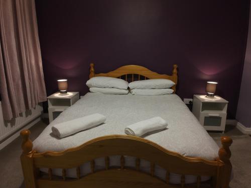 a bedroom with a large bed with two white pillows at Helens Self Catering in Castlebar