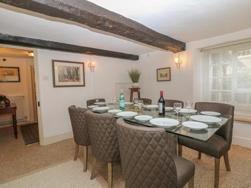 a dining room with a table and chairs at Dolphin House in Burford