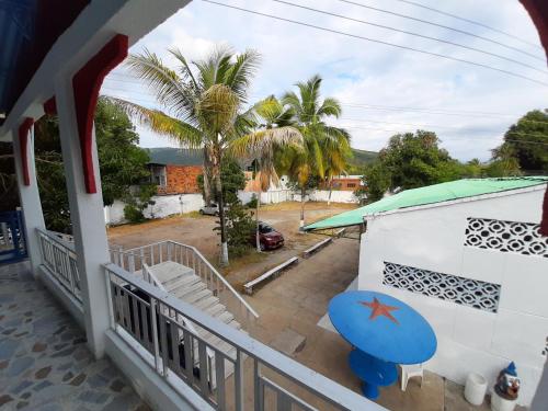 a balcony with a view of a palm tree at Hotel Sael in Tocaima