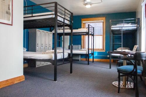 a room with three bunk beds and a desk at 11th Avenue Hostel in Denver