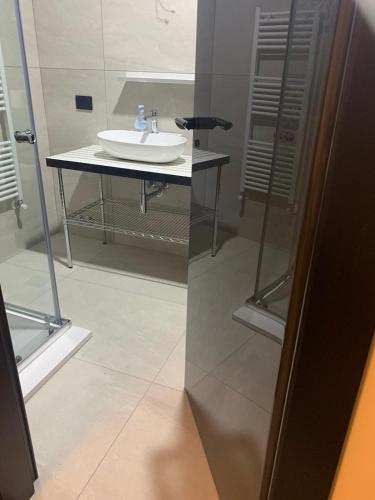 a bathroom with a white sink and a mirror at P. ROOM in Benevento
