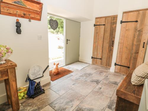 a room with a door and a tile floor at Sawmill Cottage in Belford