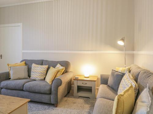 a living room with two couches and a table at The Neuk in Elgin