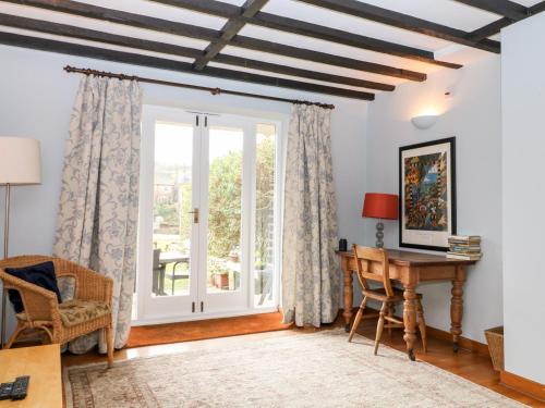 a home office with a desk and a window at Spring Bank Cottage in Highpeak Junction