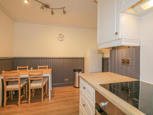 a kitchen and dining room with a table and chairs at The Neuk in Elgin