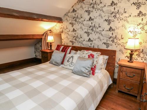 a bedroom with a bed and a wall with writing on it at Monks Cottage in Skipton