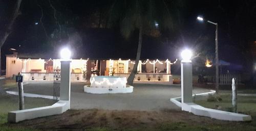 a park at night with lights in front of a building at Arachiwil Green Nature Resort in Puttalam