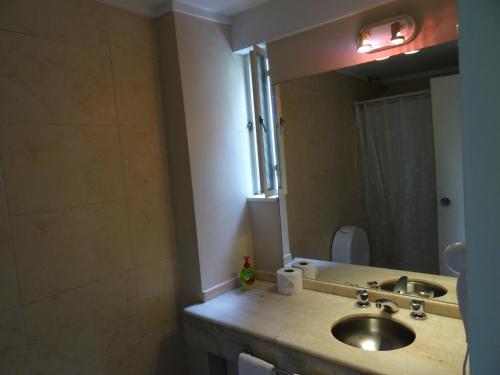 a bathroom with a sink and a mirror at Arenales Apartamento in Buenos Aires