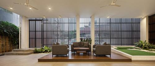 a lobby with two chairs and a large window at Sakura Terrace in Jakarta