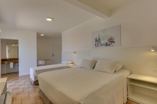 Cama ou camas em um quarto em Express Floripa Residence