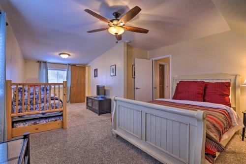 a bedroom with a bed and a ceiling fan at Downtown Cedar City House Less Than half Mi to SUU Campus! in Cedar City