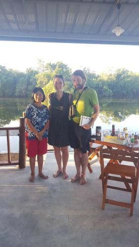 a group of people posing for a picture on a dock at Khum Thong Resort in Takua Pa