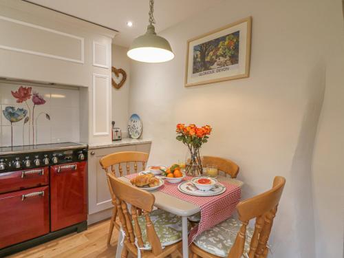 a kitchen with a table with a plate of food on it at Rookwood in Exeter
