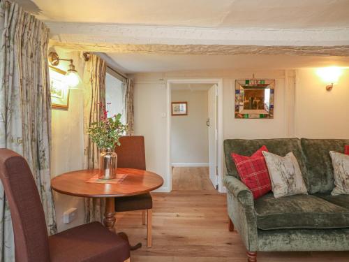 a living room with a green couch and a table at Rookwood in Exeter