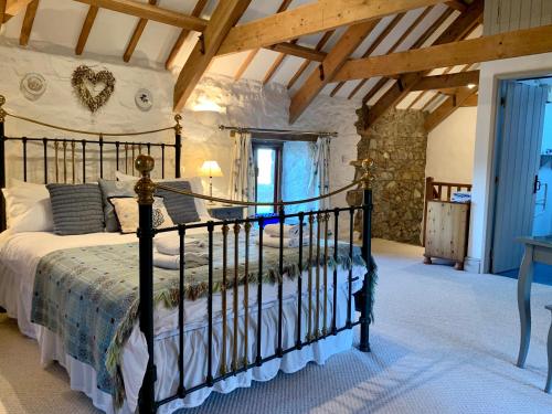 a bedroom with a large bed in a room at Stable Cottage in Newport