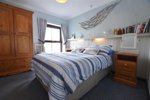 um quarto com uma cama, uma secretária e uma janela em 5 The Coach House em Haverfordwest