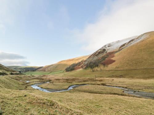 a river in the middle of a field with hills at 1 Alpine Place in Thornhill