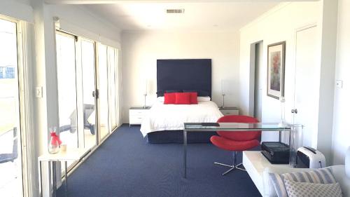 a bedroom with a bed and a glass table at Island Waterfront Getaway - WiFi in Hindmarsh Island