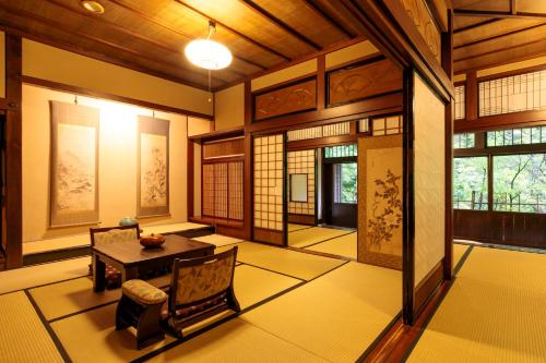 a room with a table and chairs in a building at Yumoto Choza in Takayama