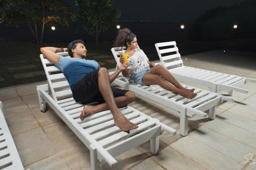 a man and a woman sitting on lawn chairs at Nilakma Lagoon in Negombo