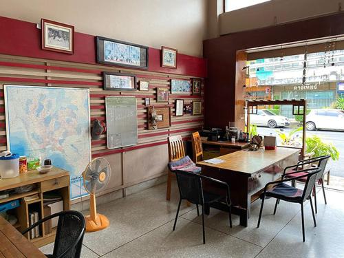 a classroom with a table and chairs and a map at Smile Guesthouse Krabi in Krabi town