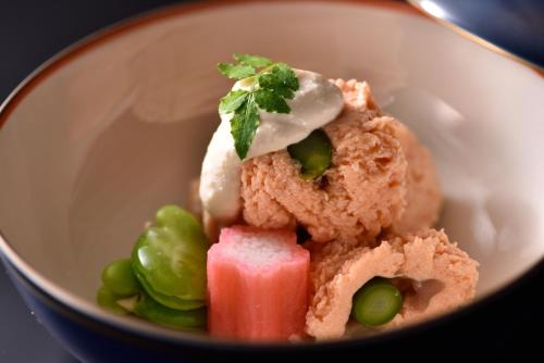a white bowl filled with food on a table at Muromachi Yutone Kyokoyado in Kyoto
