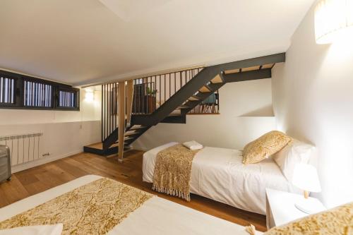 a bedroom with two beds and a staircase at Bravissimo Sacsimort in Girona