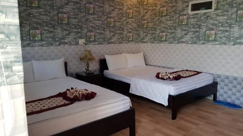 Un pat sau paturi într-o cameră la Khách sạn Ánh Đông