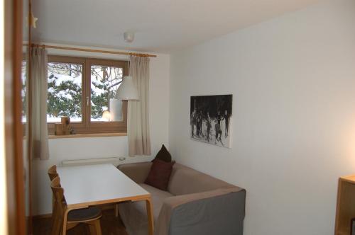 a living room with a couch and a table at Landhaus Neussl in Kaltenbach