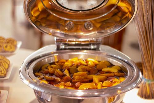 a container with food in it on a table at Le Peninsula Bay Beach Resort & Spa in Blue Bay