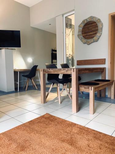 a dining room with a wooden table and chairs at Hotel-Bistro-Europa in Merchweiler