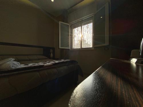 a bedroom with a bed and a window at Grand Hotel Royal in Pompei