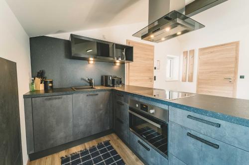 a kitchen with stainless steel appliances and a counter top at Mirador Apartments in Seefeld in Tirol