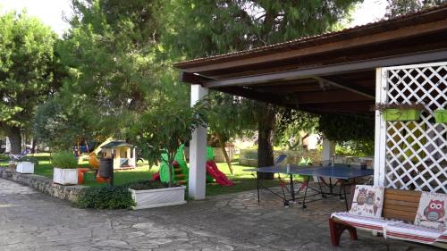 a pavilion with a picnic table in a park at Agriturismo Salinola in Ostuni