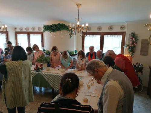 a group of people sitting around a table eating food at Agriturismo Salinola in Ostuni