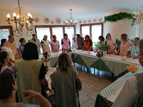 a group of people standing around tables in a room at Agriturismo Salinola in Ostuni