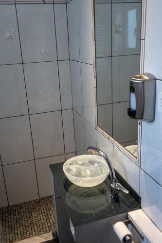 a bathroom with a sink and a mirror at HOTEL HILL in Athens