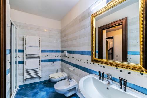 a bathroom with a sink and a toilet and a mirror at Cà Sant'Angelo in Venice