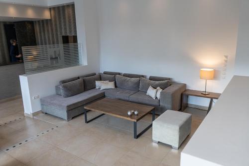 a living room with a couch and a coffee table at HOTEL HILL in Athens