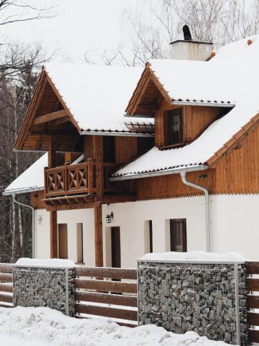 a house with snow on the roof at Uroczysko starych sztolni in Szklarska Poręba