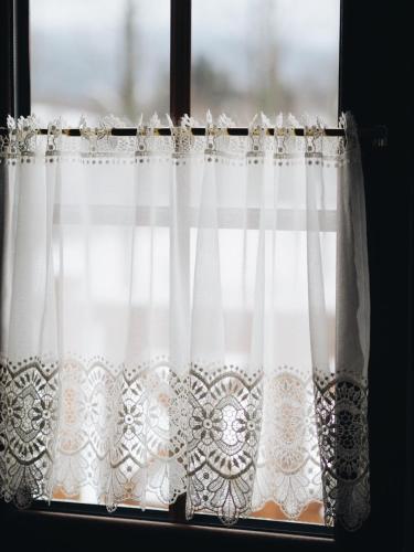 a window with white curtains in a room at Uroczysko starych sztolni in Szklarska Poręba