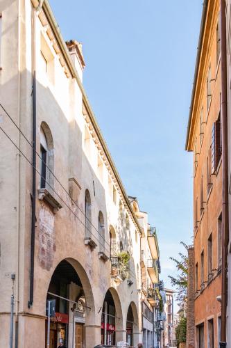 an old building with an archway on a city street at Collalto24 in Treviso