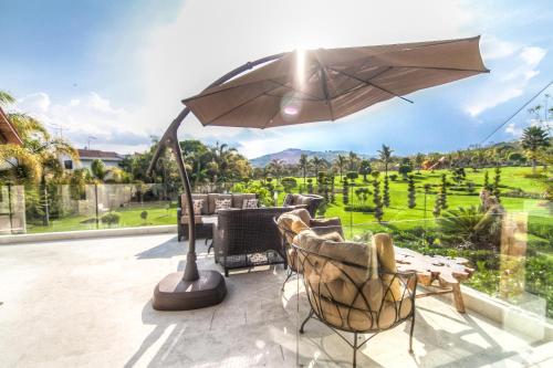 a patio with a table and an umbrella at Hotel Boutique Matea in Ixtapan de la Sal