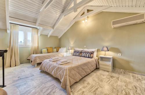 a bedroom with two beds and a window at Avesta Apartments in Vasilikos