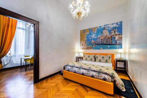 a bedroom with a bed and a painting on the wall at Cà Sant'Angelo in Venice