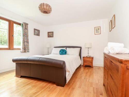 a bedroom with a bed and a wooden floor at Ocean Blue in Penzance