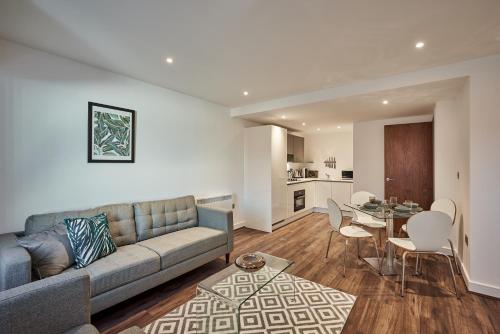 a living room with a couch and a table at Seven Living Jewellery Quarter in Birmingham