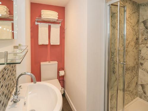 a bathroom with a toilet and a sink and a shower at The Farmhouse Kitchen in Ripon