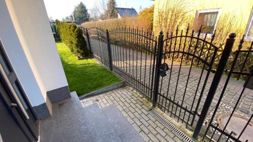 a wrought iron fence in front of a house at Ferienwohnung Fink in Berlin